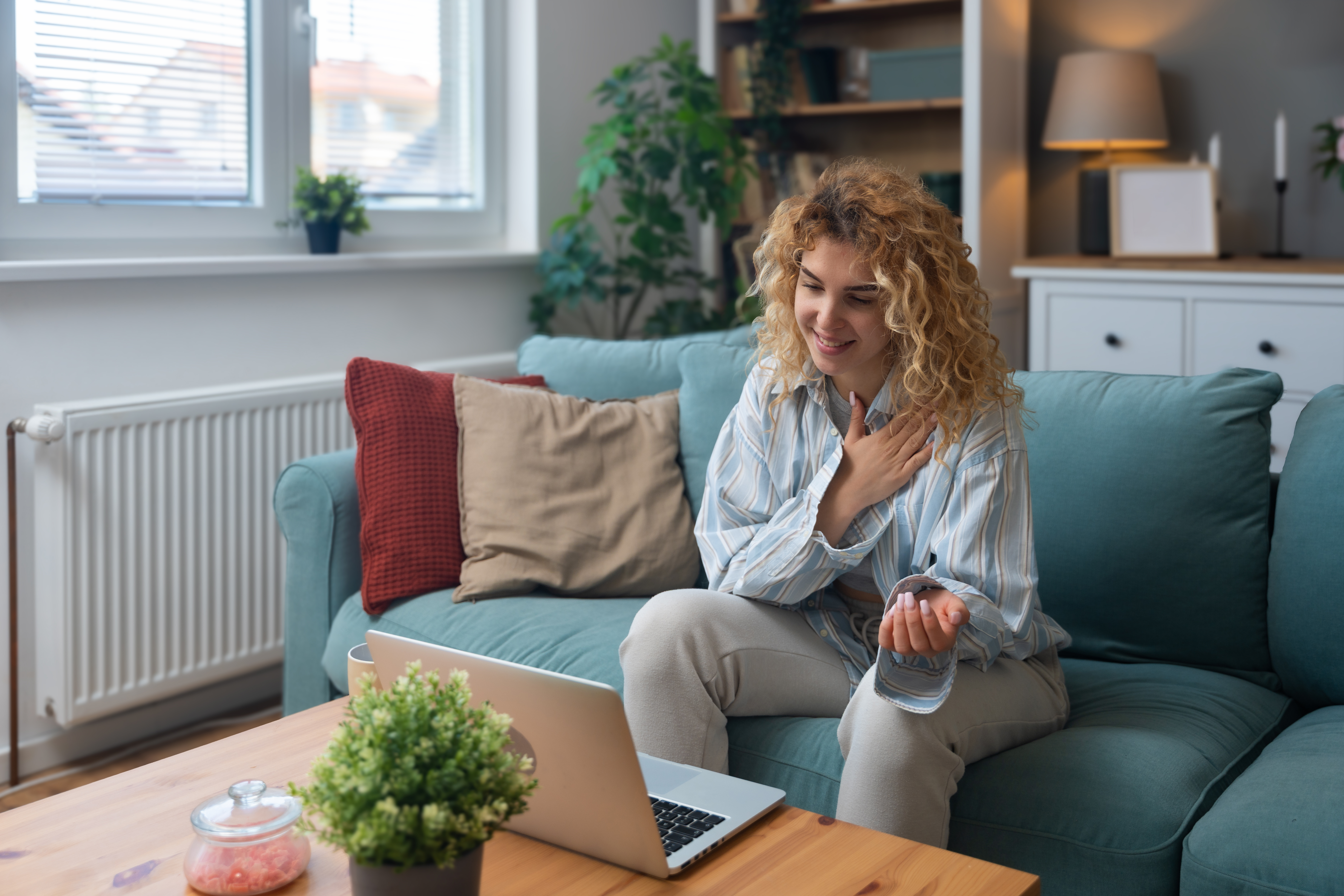 Young woman talking on video call with her psychotherapist doctor after online therapy sessions, happy that she is well and mentally health now after telemedicine conversations. Thank you for help